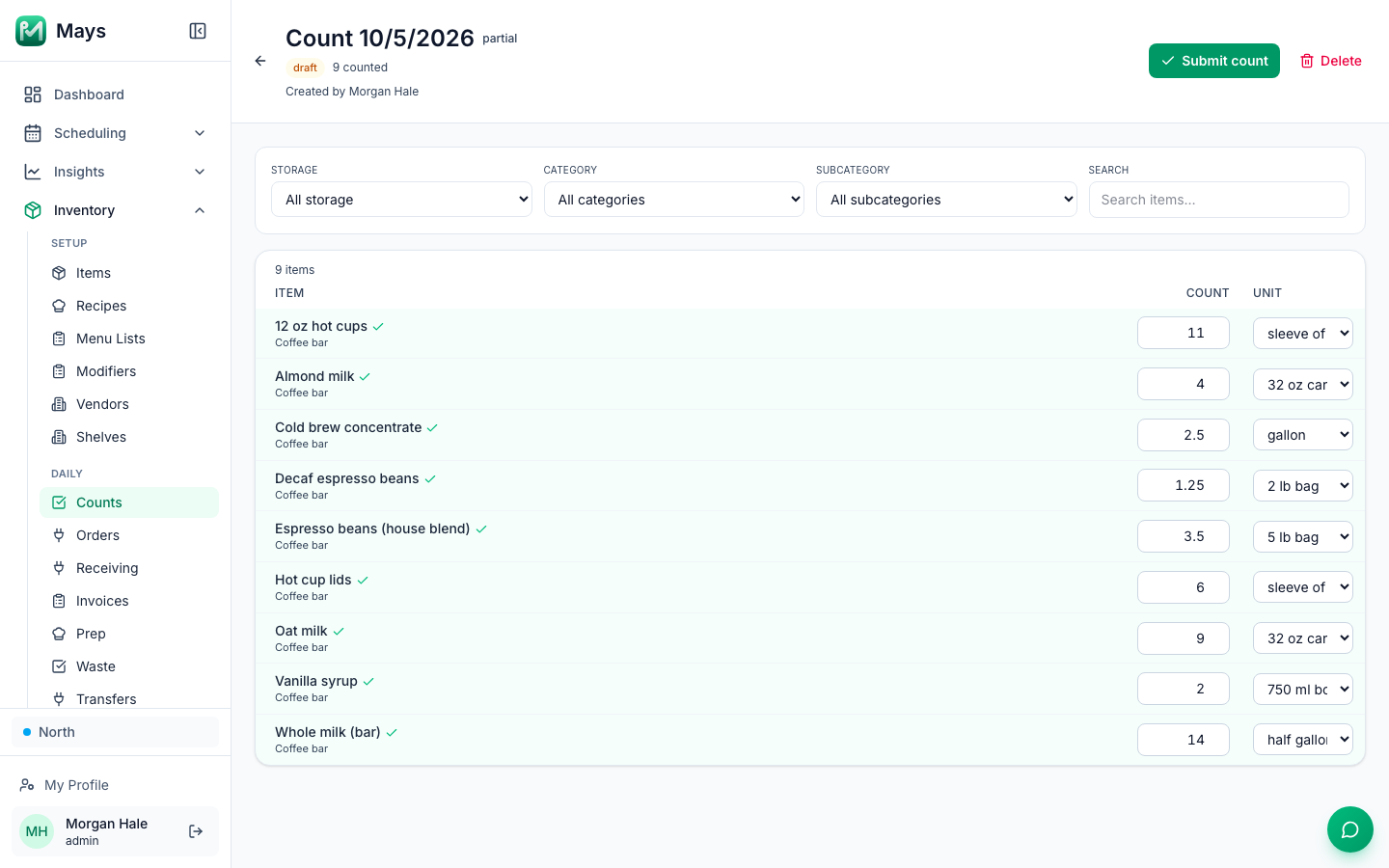 A partial inventory count in Mays dated October 5, 2026 for the coffee bar, with nine items counted, from espresso beans in 5 lb bags and whole, oat and almond milk to cold brew concentrate, vanilla syrup, hot cups and lids