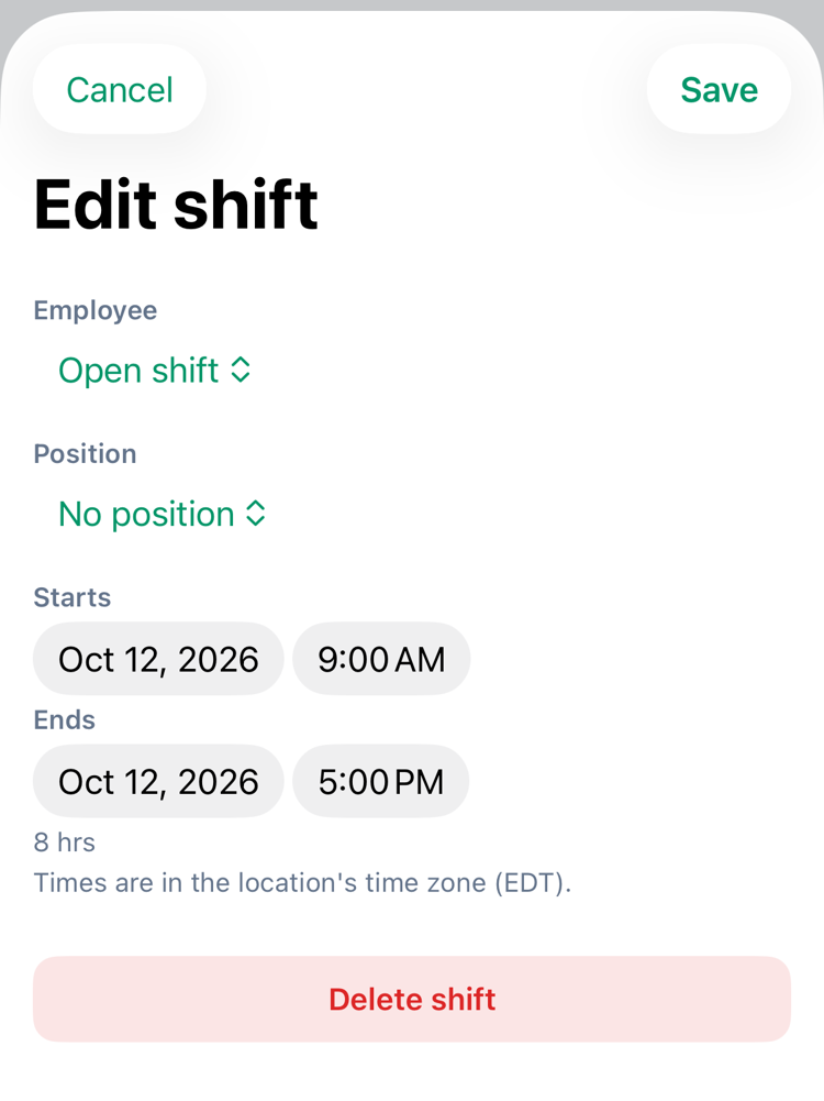The Edit shift sheet on iPhone for an open shift: Employee Open shift, Position No position, Starts Oct 12, 2026 9:00 AM, Ends Oct 12, 2026 5:00 PM, 8 hrs, the note Times are in the location's time zone (EDT), and Delete shift