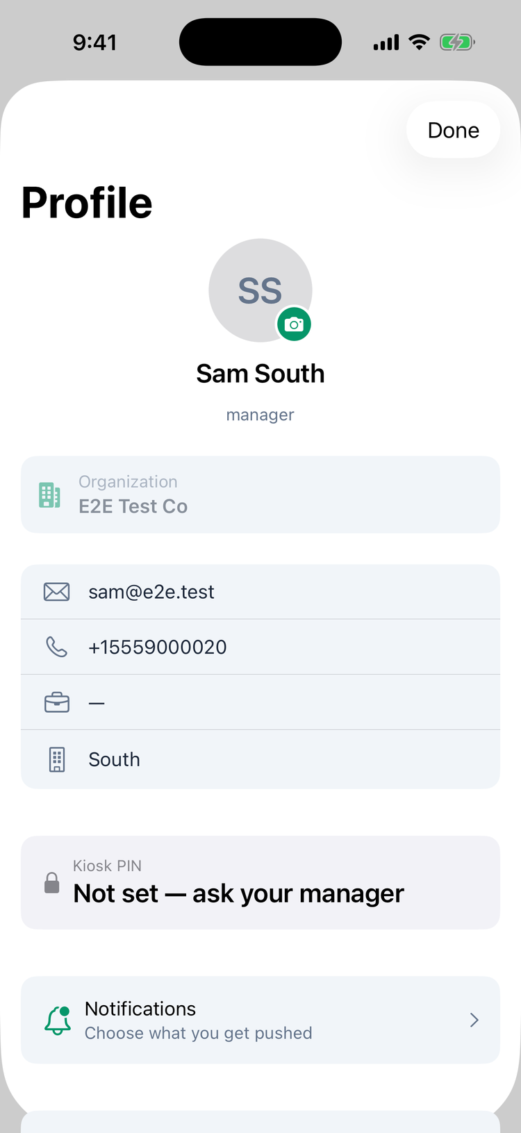 The top of Profile on iPhone: the picture with a camera button, the name Sam South and manager, the Organization card E2E Test Co, the email, phone, an empty department and the location South, the Kiosk PIN card saying Not set — ask your manager, and Notifications