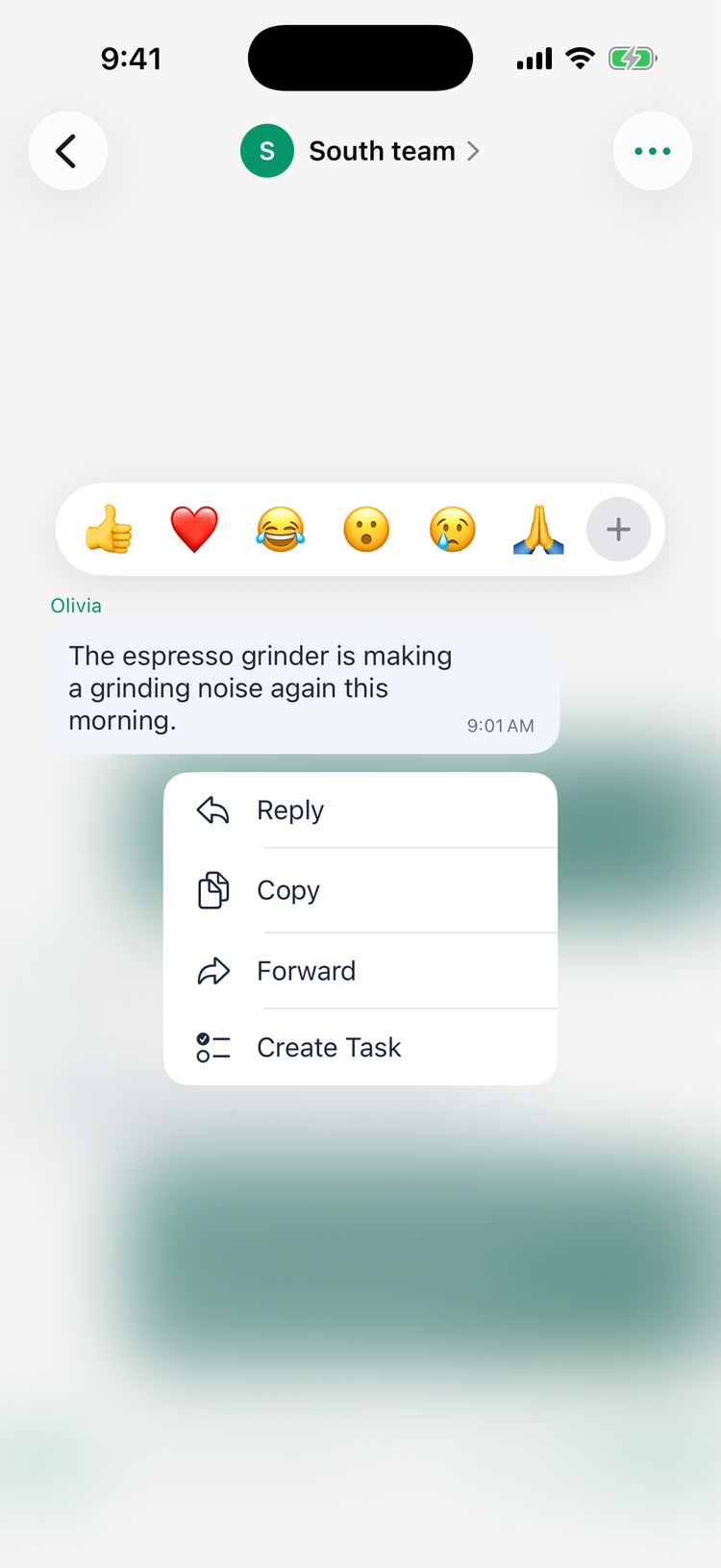 A chat message on iPhone held down to show its menu: the reactions, and Reply, Copy, Forward and Create Task