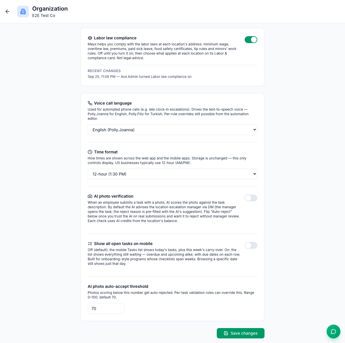 The Organization settings page for E2E Test Co: the Labor law compliance card switched on, with its explanation and Recent changes — Ava Admin turned Labor law compliance on; then Voice call language set to English, Time format set to 12-hour (1:30 PM), AI photo verification and Show all open tasks on mobile switched off, AI photo auto-accept threshold 70, and the Save changes button